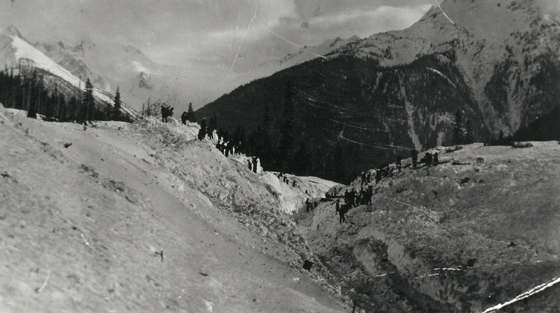 Black and white photograph of disaster site looking from the summit of mountain pass.